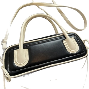 Fashionable black and white patchwork baguette bag with adjustable shoulder strap
