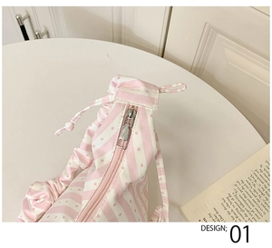 Close-up of pink and white striped pleated dumpling bag with silver metal zipper detail