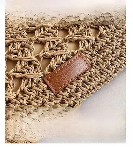 Macro shot of hand-woven straw texture and premium brown leather detail on shoulder bag