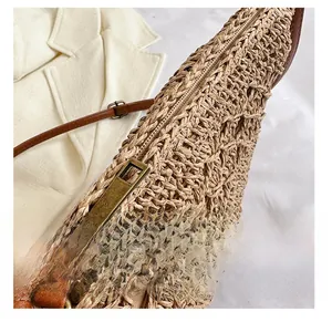 Close-up of smooth metal zipper and premium woven texture on a straw crossbody bag