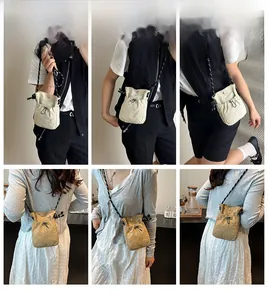 Detail view of mini drawstring bucket bag showing adjustable cords and nylon texture