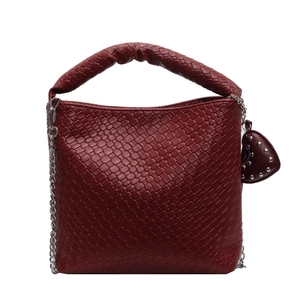 Reddish brown woven bucket bag with thick braided handle and silver chain strap
