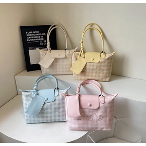 Detailed view of checkered tote bag sets with cartoon characters and matching small pouches
