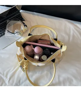 Top view showing the spacious interior of a checkered tote bag with daily essentials