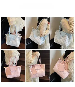 Detail view of large plaid tote bag and matching mini pouch with knot handle design