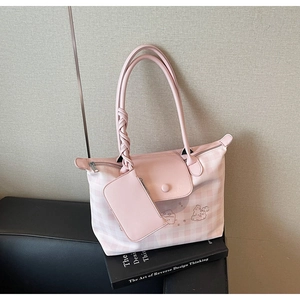 Detailed shot of pink checkered tote bag with woven knot handle and a matching small pouch