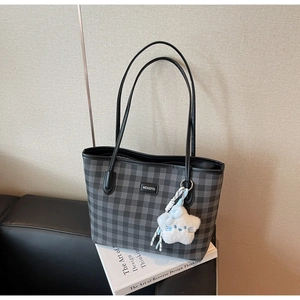 Detail of grey checkered tote bag with MEIGEFEI leather patch and white star charm