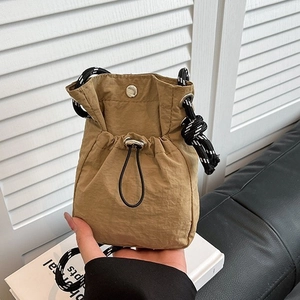 Khaki nylon mini bucket bag with adjustable drawstring and woven rope shoulder strap
