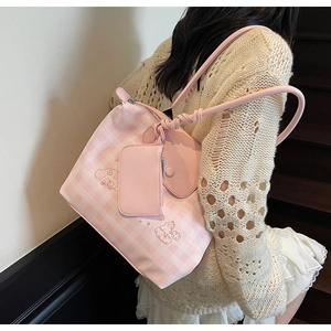 Detail of pink plaid tote bag set featuring cute character embroidery and leather straps