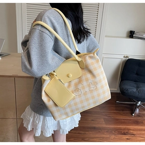 Close-up of yellow checkered tote bag featuring cute animal embroidery and mini pouch