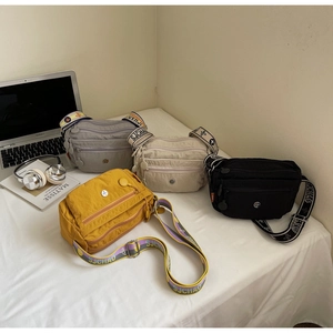 Detailed view of oxford fabric crossbody bags in four colors with multi-pocket design