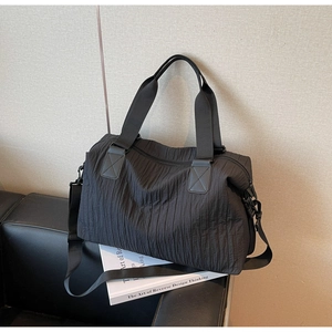 Detailed view of black large capacity canvas tote with unique vertical pleated texture fabric