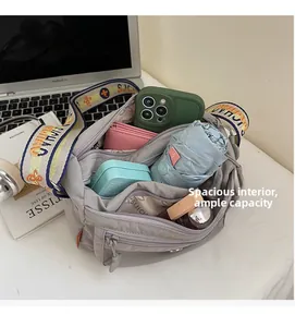 Spacious interior of gray nylon crossbody bag with multi-layer storage for daily essentials
