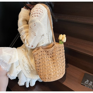 Detailed macro view of woven straw bucket bag with intricate hollow crochet patterns
