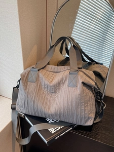 Large gray pleated canvas tote bag with adjustable strap for commuting and daily travel