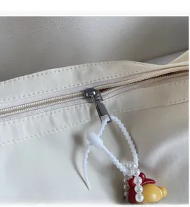 Détail de la fermeture éclair sur sac en toile avec pendentif de dessin animé mignon