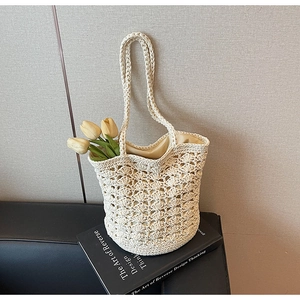 Detailed close-up of ivory crochet tote bag featuring intricate openwork patterns and lining