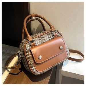 Close-up of retro brown plaid crossbody bag with faux leather trim and dual handles