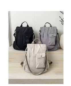 Detailed shot of multi-color nylon backpacks on stone steps with modern texture