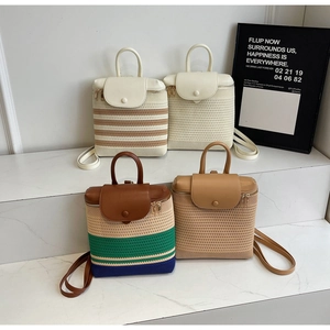 Detail showing various straw woven backpacks with leather trim in four different colorways