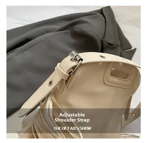 Close-up of adjustable cream PU leather shoulder strap with metallic pin buckle and eyelets