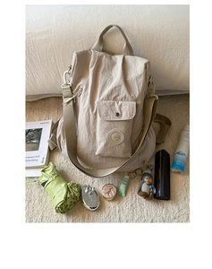 Spacious beige nylon backpack with accessories showing large storage capacity