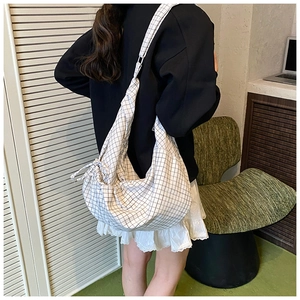 Detail of checkered hobo bag showing spacious design and soft cotton canvas texture