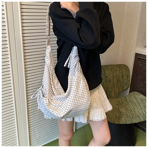 Detail of the black and white grid pattern canvas hobo bag showing large capacity and zipper