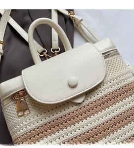 Close-up of beige leather flap and bicolor woven texture on a minimalist backpack