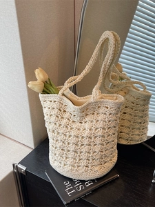 Handcrafted cream crochet bucket tote bag with hollow wave patterns for beach vacations