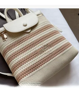 Detailed macro of the woven straw texture and premium leather flap on this dual-shoulder bag