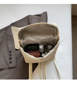 Spacious interior of a woven straw backpack showing large capacity for wallet and cosmetics