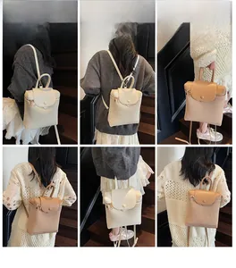Detail showing woven straw backpacks in cream and khaki with adjustable shoulder straps