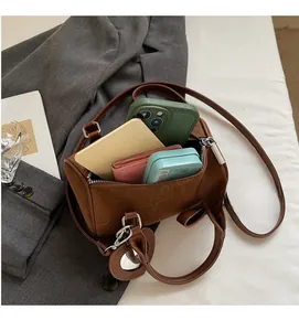 Detail view of brown cylinder bag interior showing high capacity for essentials