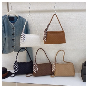 Collection of woven underarm bags in five neutral colors with elegant polka dot scarves