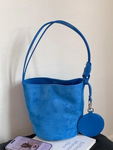 Blue frosted bucket bag with knot shoulder strap and round coin purse accessory