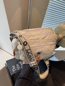 Classic beige oxford fabric crossbody bag with multiple pockets and wide floral strap