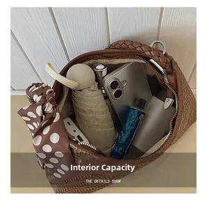 Spacious interior of brown woven bucket bag showing capacity for phone and cosmetics