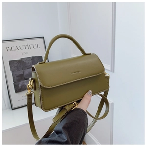 Detail view of olive green leather handbag with embossed logo and gold metal hardware