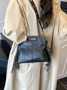 Large black leather tote bag with long tassels and hollow handle for women in summer