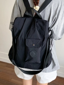 Minimalist black waterproof nylon backpack for women with adjustable straps and front pocket