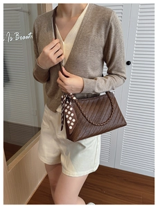 Detailed weave of dark brown hobo bag with polka dot silk scarf in home setting