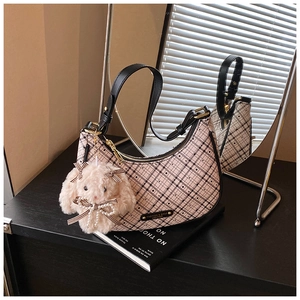 Detail of pink plaid hobo bag with adjustable strap and cute plush rabbit charm