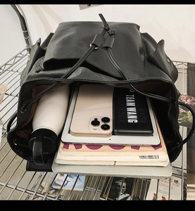 Macro view of the large capacity interior of a black PU leather vintage backpack