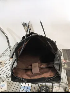 Detail view of large capacity vintage backpack with padded laptop sleeve and brown elastic strap