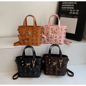 Four colors of monogram bucket bags featuring stylish dog pendants and metal handles