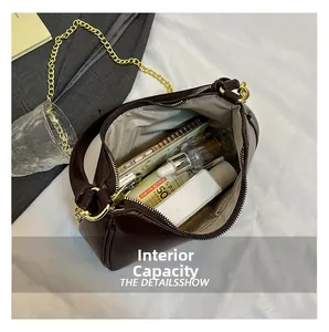 Deep brown oil-wax leather shoulder bag showing spacious interior with herringbone lining