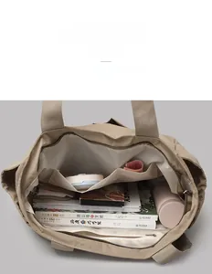 Internal view of khaki large capacity tote bag with organized compartments and daily essentials