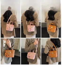 Detail showing monogram pattern bucket bags with puppy charms on a female model