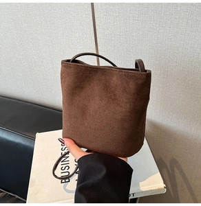 Detailed close-up of dark brown matte suede bucket bag showing its premium retro texture